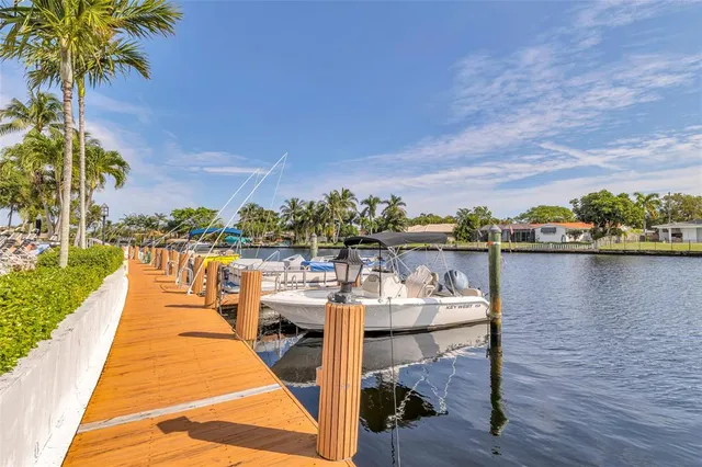 a living room with furniture and floor to ceiling window