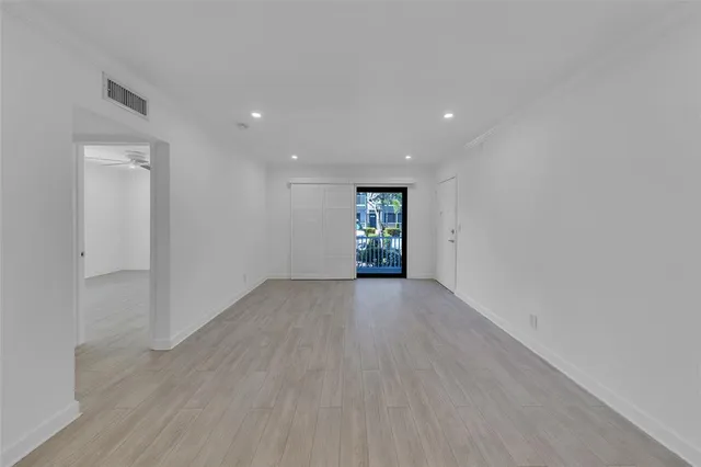 a view of walk in closet with empty racks