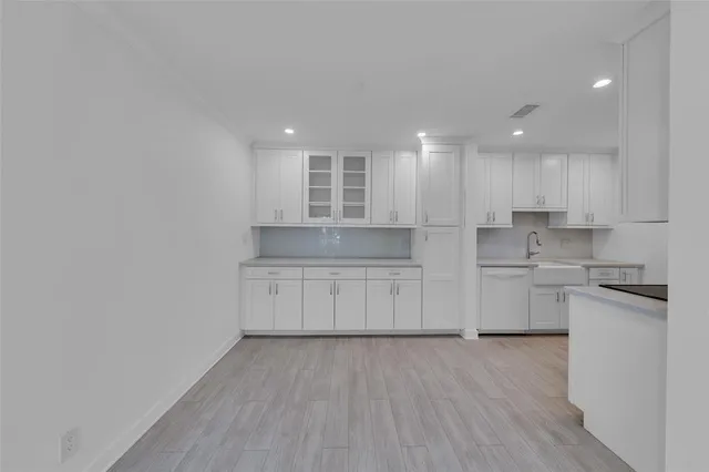 a kitchen with a refrigerator and a stove top oven