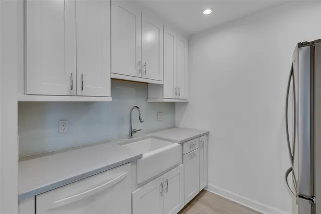 a kitchen with stainless steel appliances a stove microwave and sink