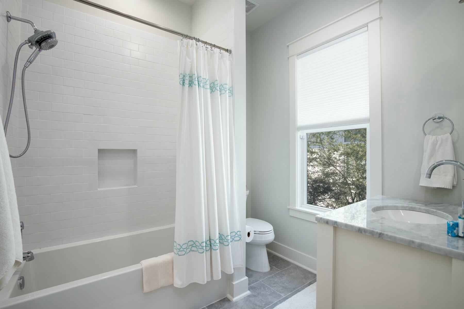 91 Catface Dr Inlet Beach Inlet Beach, FL 32461 - Photo 18 of 23 a bathroom with a granite countertop bathtub shower sink vanity and toilet