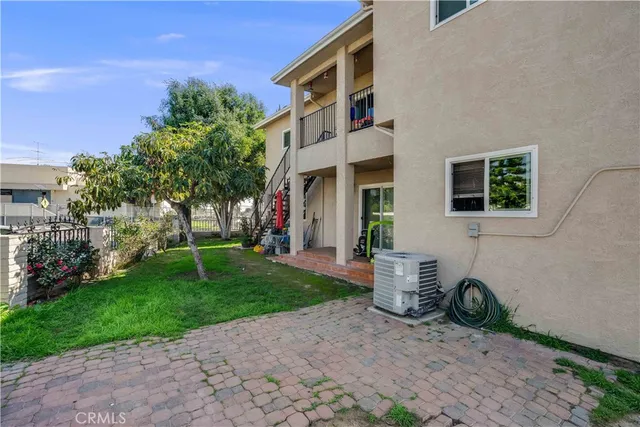 a backyard of a house with barbeque oven fire pit and chairs