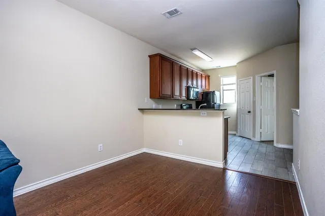 a view of a kitchen with a sink and a refrigerator