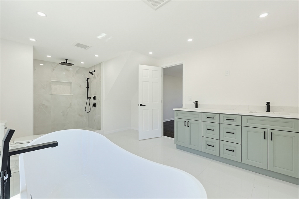 175 Pleasant Street Upton, MA 01568 - Photo 20 of 39 a spacious bathroom with double vanity and a mirror