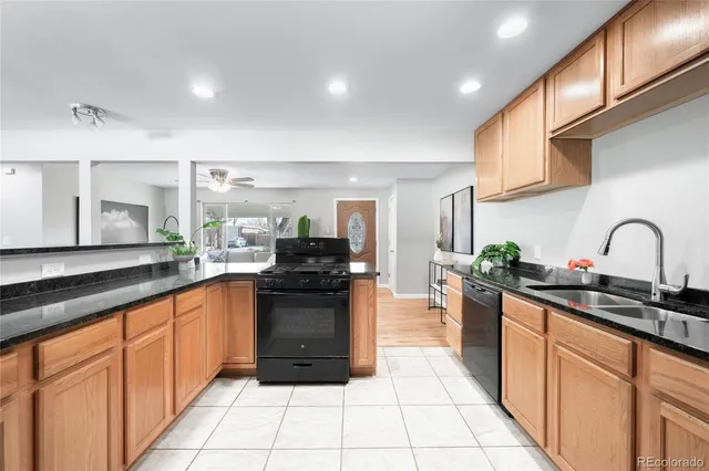 a kitchen with stainless steel appliances granite countertop a sink and cabinets
