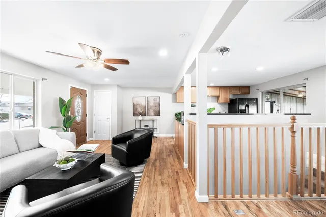 a living room with furniture and wooden floor