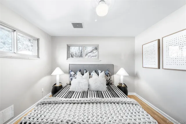 a bed room with a bed and a painting on the wall