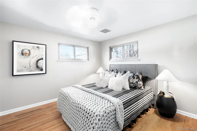 a bedroom with a bed and a painting on the wall