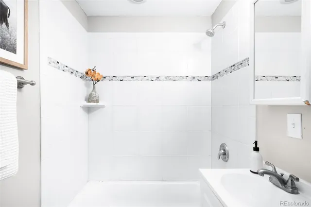 a bathroom with a shower and a sink
