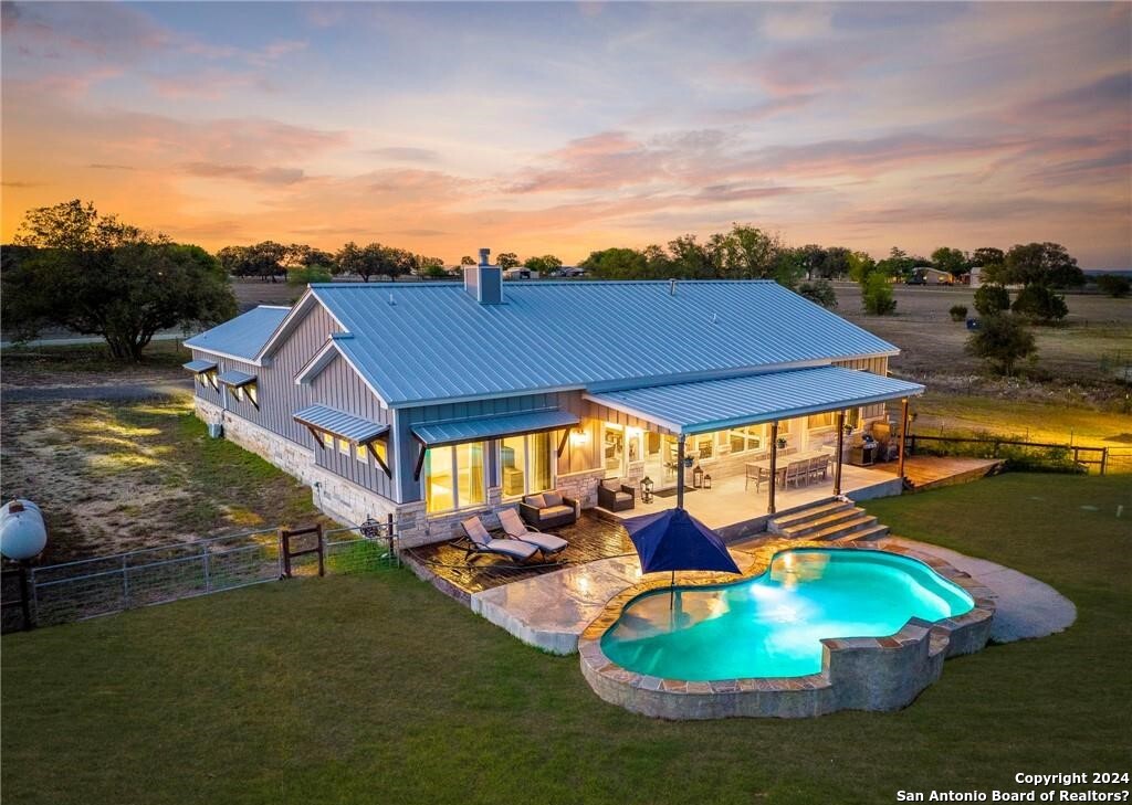 an aerial view of a house with a swimming pool