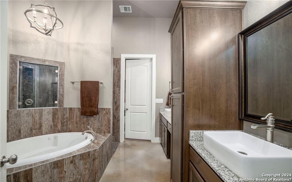 345 Laguna Road Bandera, TX 78003 - Photo 13 of 35 a bathroom with a tub sink and mirror