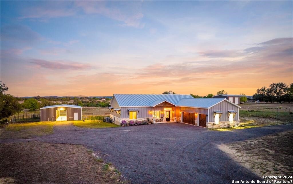 345 Laguna Road Bandera, TX 78003 - Photo 35 of 35 a view of house with swimming pool and mountains in the background
