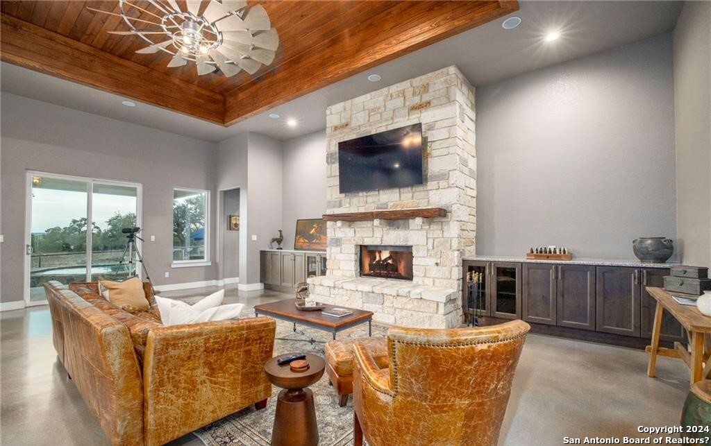 345 Laguna Road Bandera, TX 78003 - Photo 5 of 35 a living room with fireplace furniture and a flat screen tv