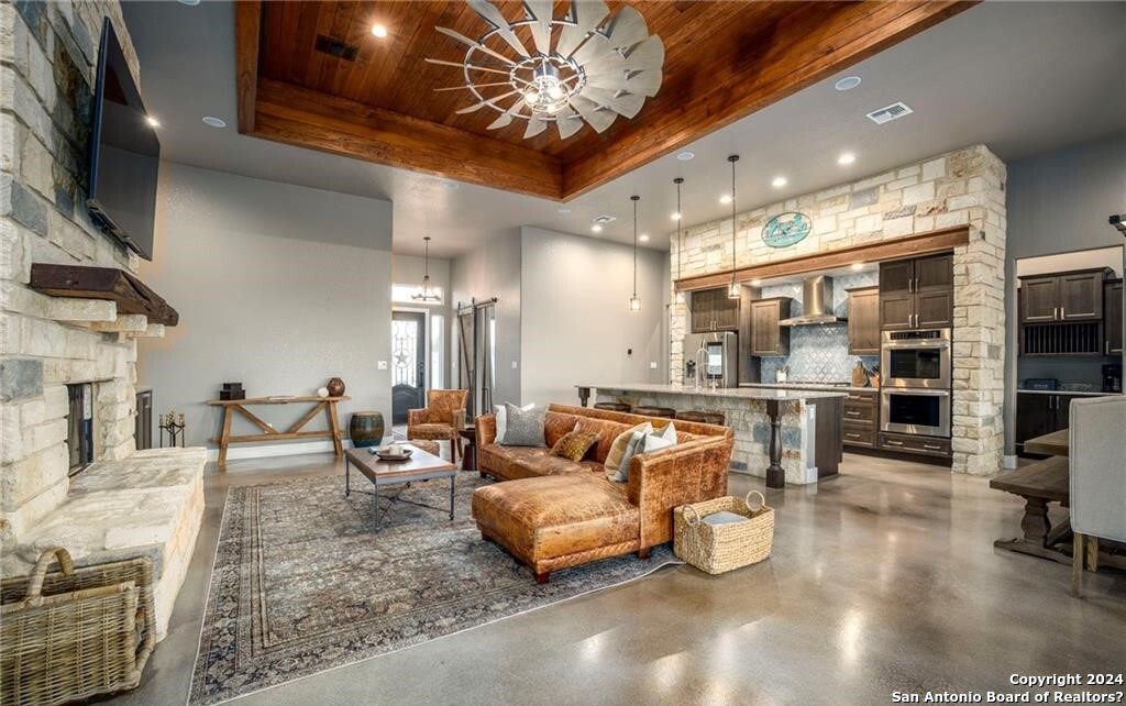 345 Laguna Road Bandera, TX 78003 - Photo 6 of 35 a living room with furniture and a flat screen tv