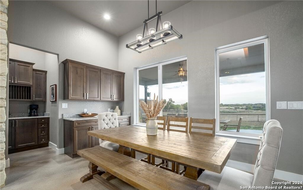 345 Laguna Road Bandera, TX 78003 - Photo 9 of 35 a view of a dining room with furniture a chandelier and wooden floor