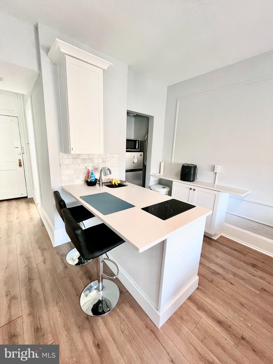 1324 Locust Street, Unit 1410 Philadelphia, PA 19107 - Photo 1 of 9 a dining room with wooden floor and large window