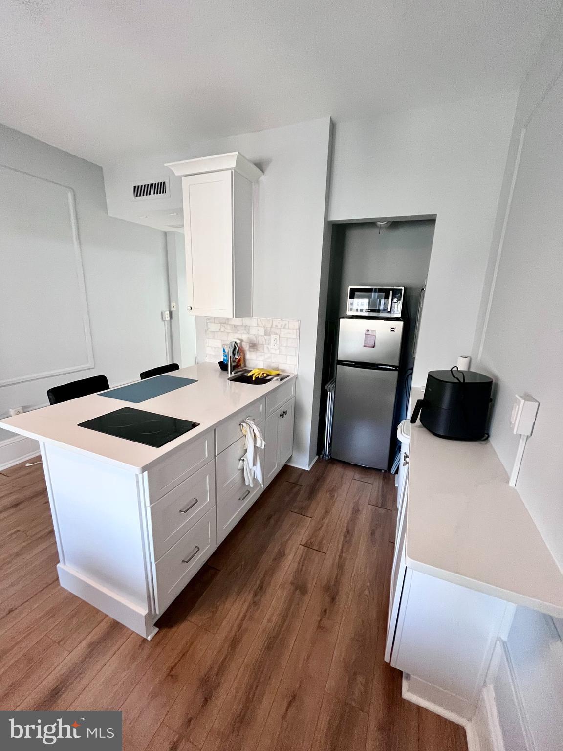 1324 Locust Street, Unit 1410 Philadelphia, PA 19107 - Photo 2 of 9 a kitchen with stainless steel appliances a white stove top oven a sink and dishwasher