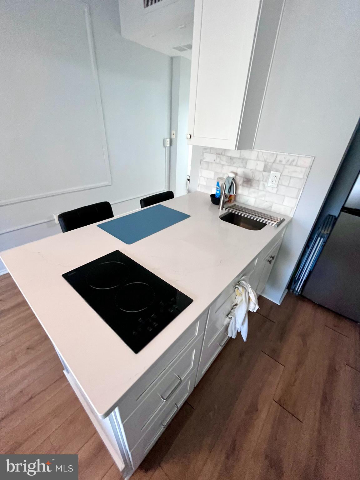 1324 Locust Street, Unit 1410 Philadelphia, PA 19107 - Photo 5 of 9 a kitchen with a sink a stove and a microwave