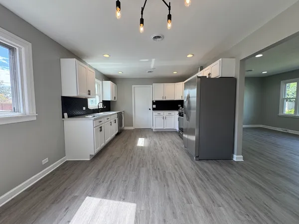a kitchen with stainless steel appliances a refrigerator sink microwave and cabinets