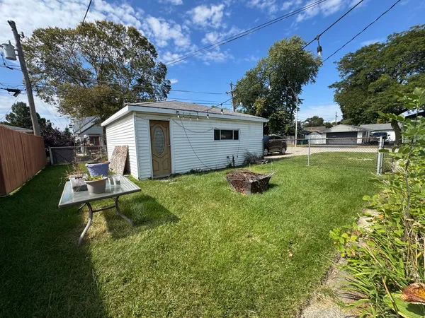 a backyard of a house with table and chairs