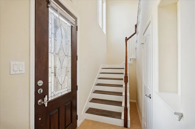 a view of entryway with wooden floor and stairs