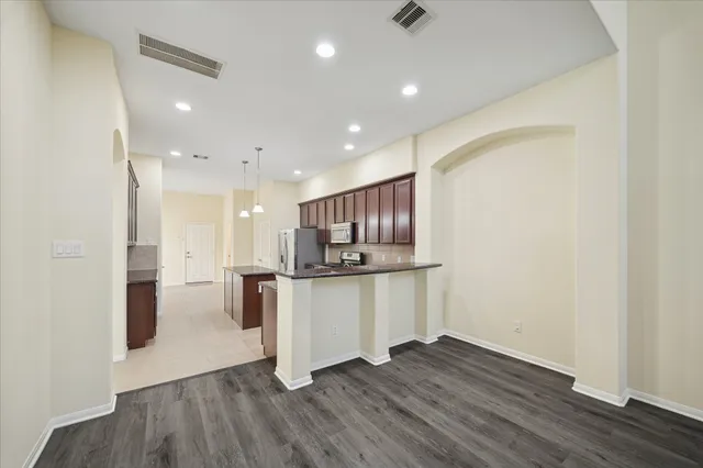 a kitchen with a refrigerator and a sink