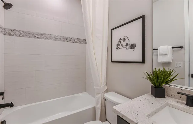 a bath room with a bathtub and a shower