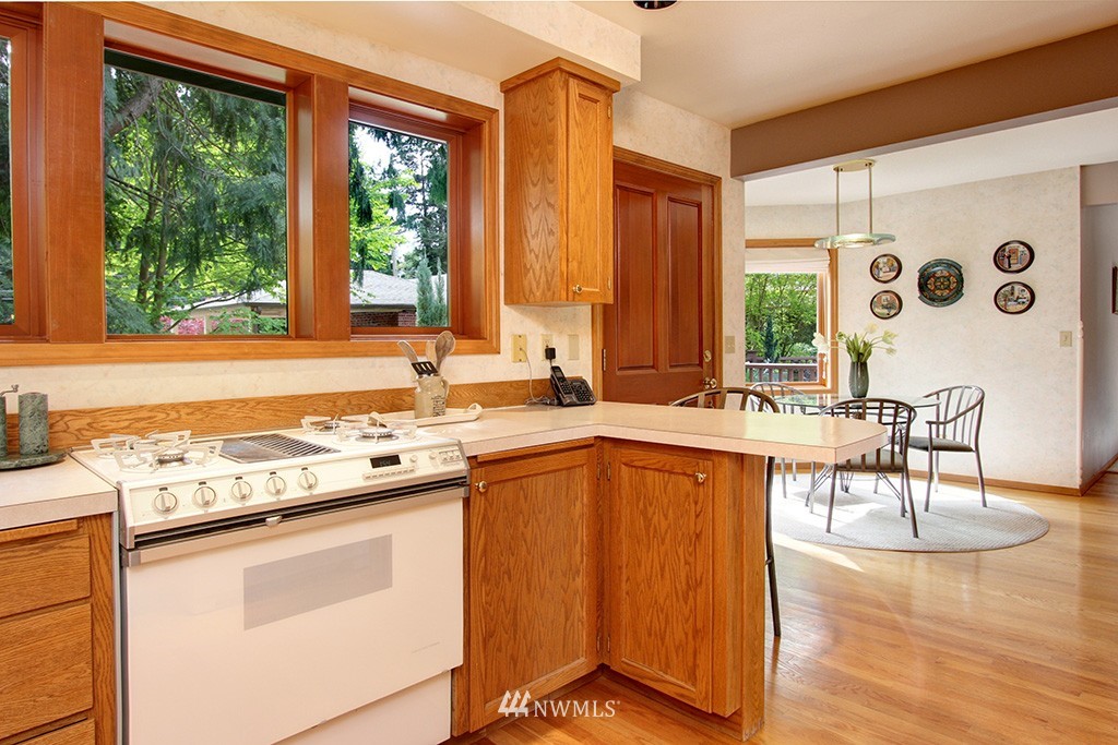 2649 Northwest 96th Street Seattle, WA 98117 - Photo 11 of 25 a kitchen with stainless steel appliances granite countertop a stove a sink and a refrigerator