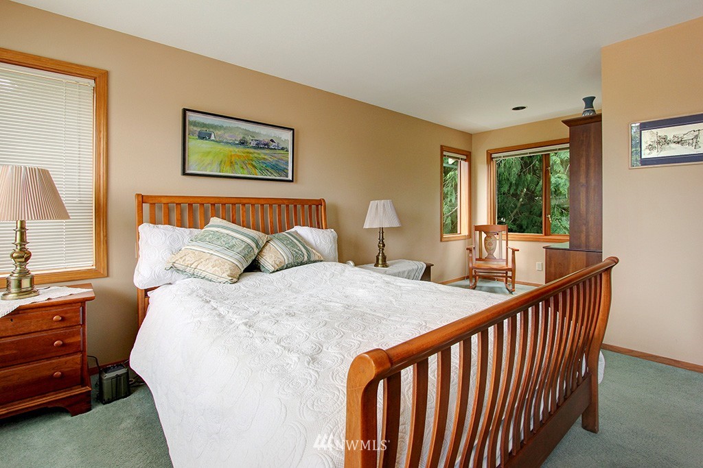 2649 Northwest 96th Street Seattle, WA 98117 - Photo 14 of 25 a bed sitting in a bedroom next to a window