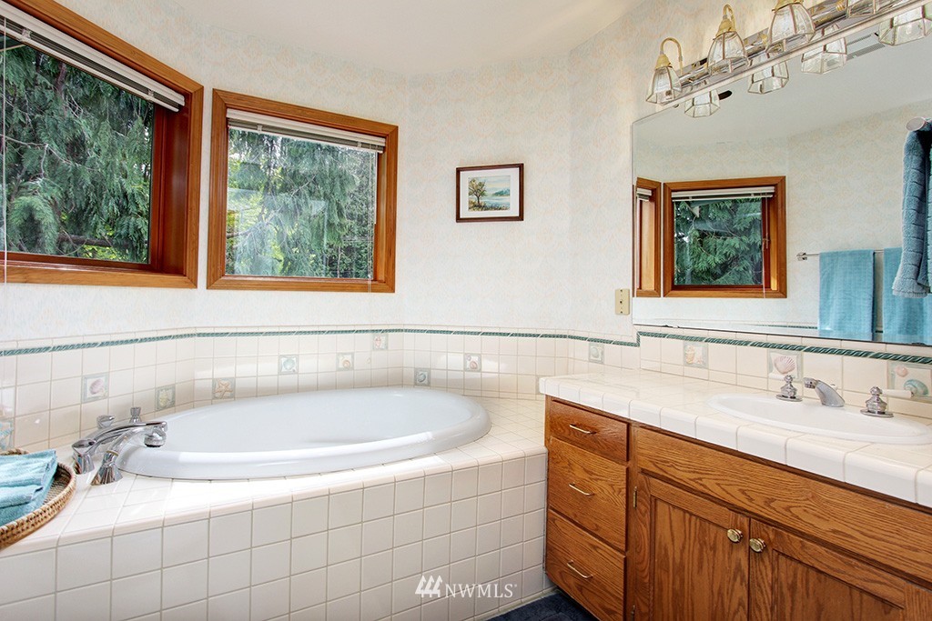 2649 Northwest 96th Street Seattle, WA 98117 - Photo 16 of 25 a bathroom with a tub sink and window