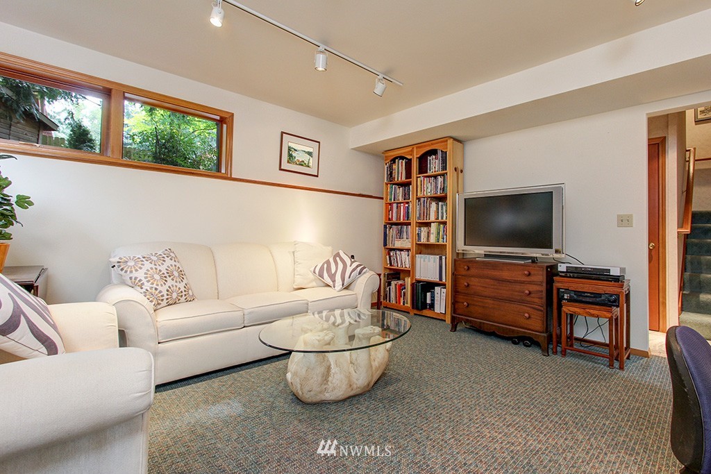 2649 Northwest 96th Street Seattle, WA 98117 - Photo 19 of 25 a living room with furniture and a flat screen tv