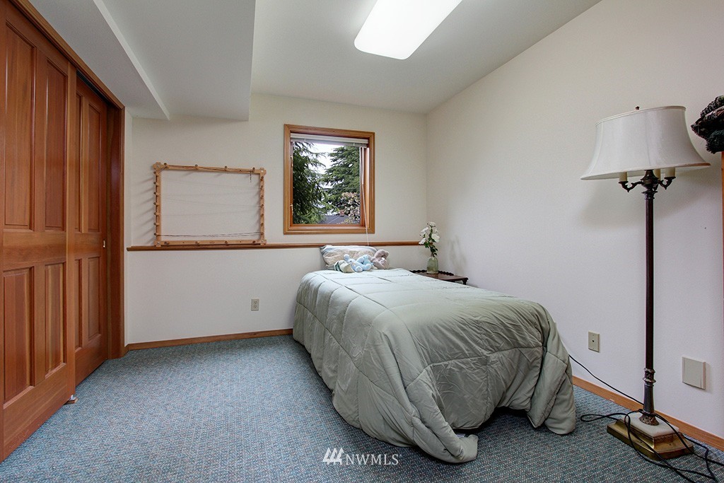 2649 Northwest 96th Street Seattle, WA 98117 - Photo 21 of 25 a bedroom with a bed and a window