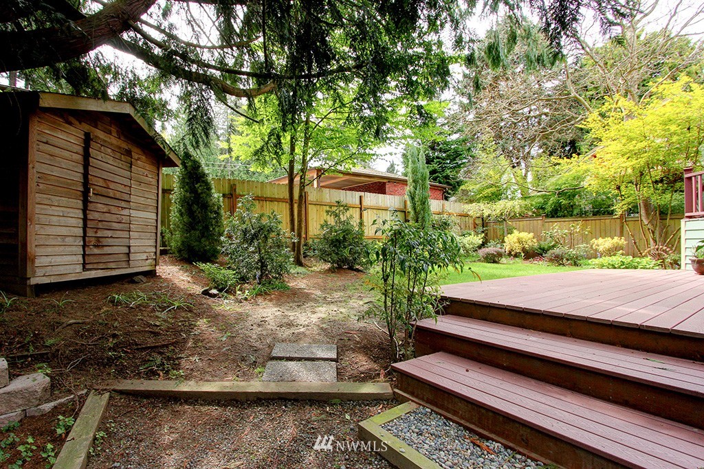 2649 Northwest 96th Street Seattle, WA 98117 - Photo 25 of 25 a wooden bench sitting in front of a house