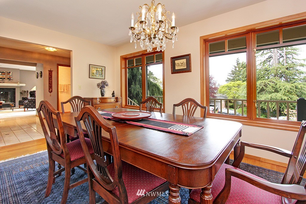 2649 Northwest 96th Street Seattle, WA 98117 - Photo 8 of 25 a dining room with furniture a chandelier and window