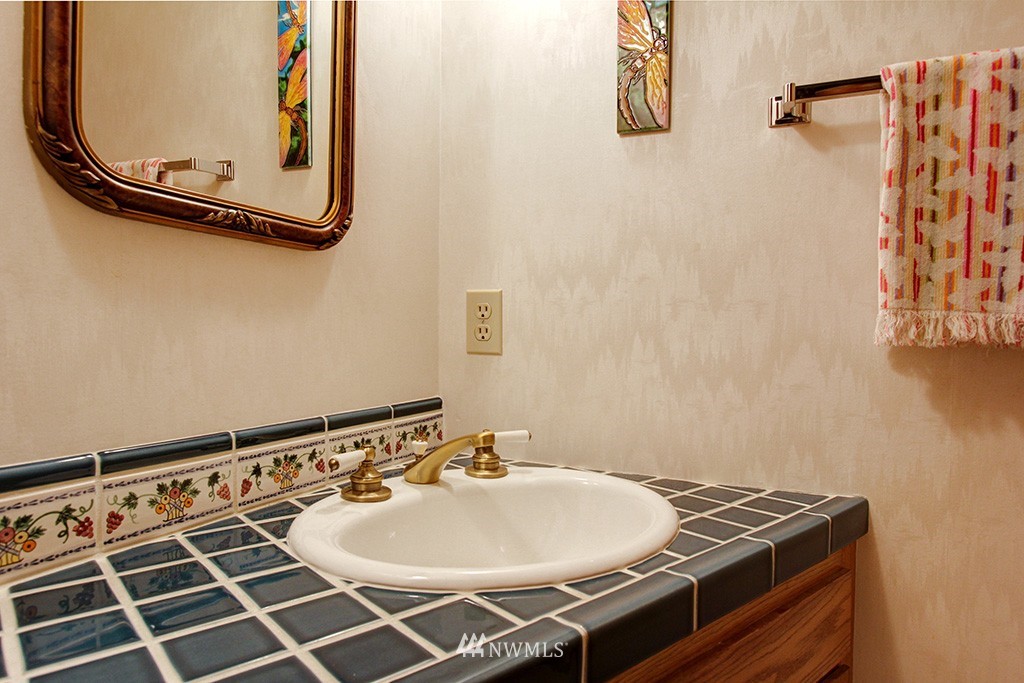2649 Northwest 96th Street Seattle, WA 98117 - Photo 9 of 25 a bathroom with a sink and a mirror