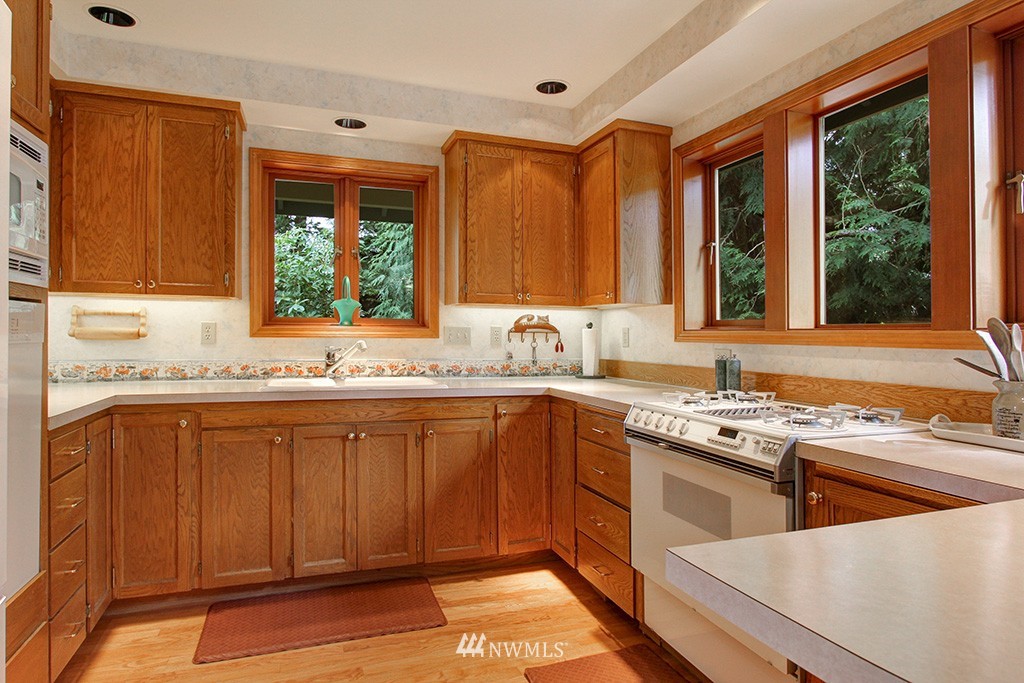 2649 Northwest 96th Street Seattle, WA 98117 - Photo 10 of 25 a kitchen with stainless steel appliances granite countertop a sink stove and cabinets