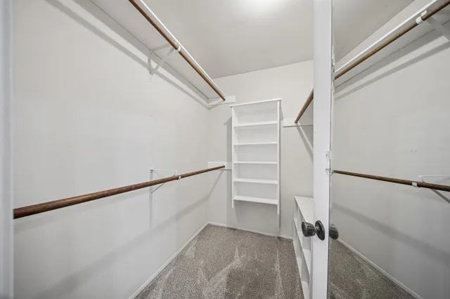 an empty room with a ceiling fan and a window