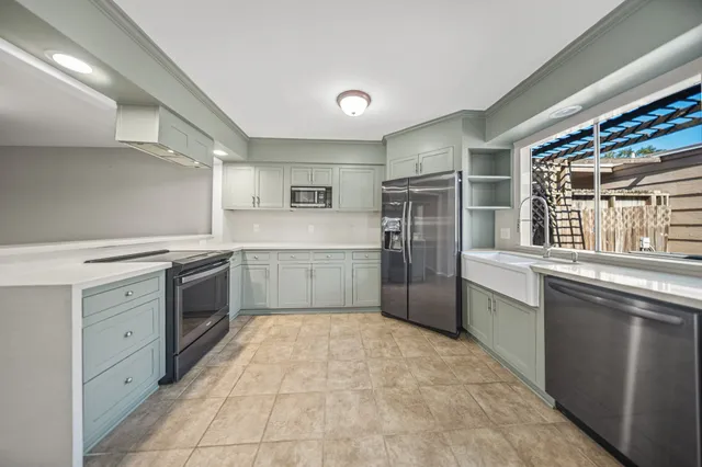 a kitchen with a cabinets sink and stainless steel appliances