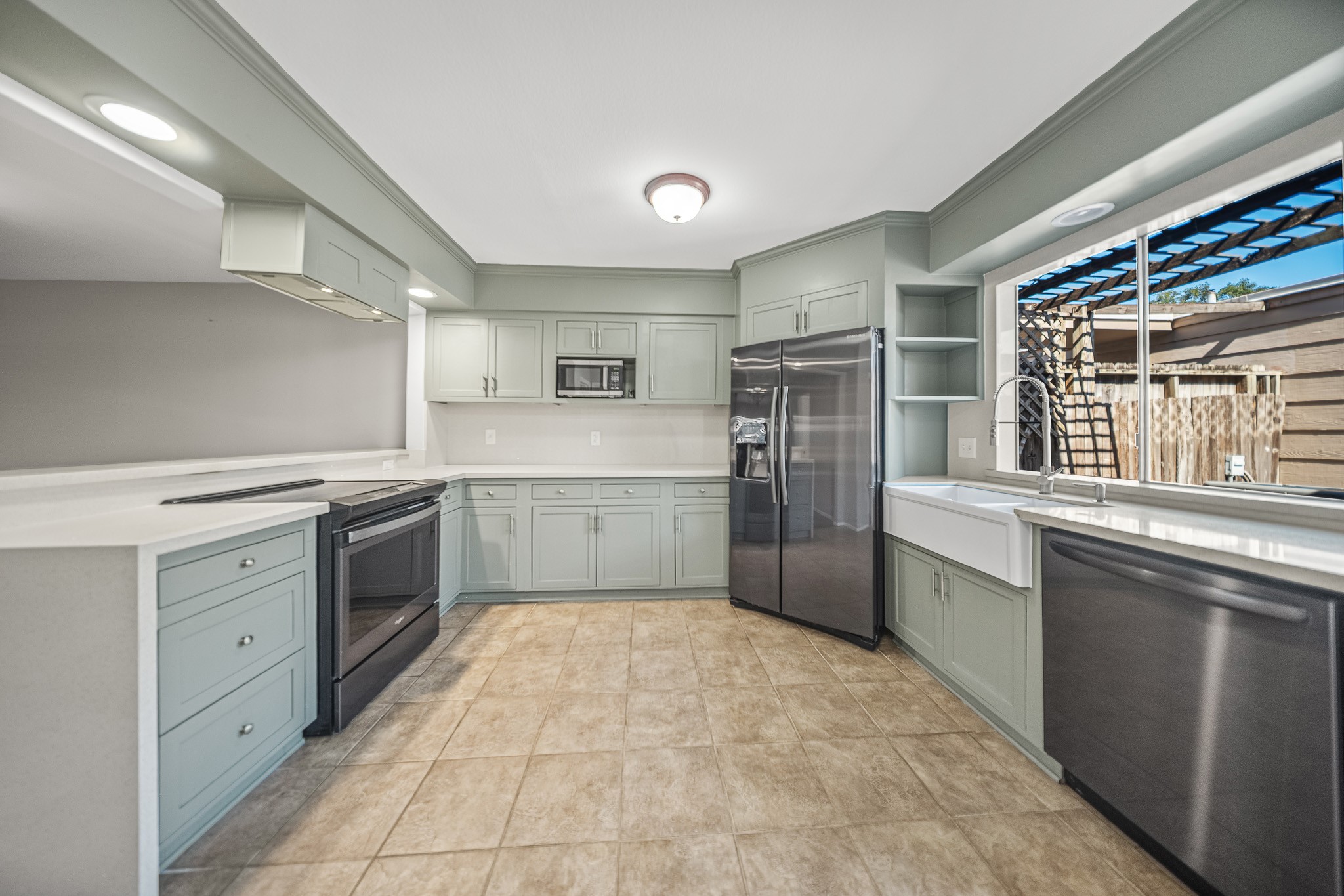 5814 Langfield Road, Unit 5814 Houston, TX 77092 - Photo 7 of 35 a kitchen with a cabinets sink and stainless steel appliances