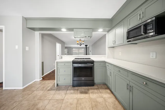 a kitchen with stainless steel appliances granite countertop a sink and cabinets