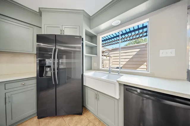 a kitchen with stainless steel appliances a refrigerator and a sink