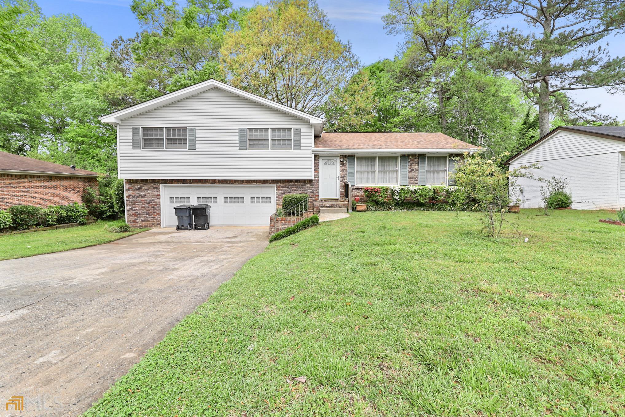 6489 Cameron Road Morrow, GA 30260 - Photo 1 of 1 a front view of a house with a yard and garage