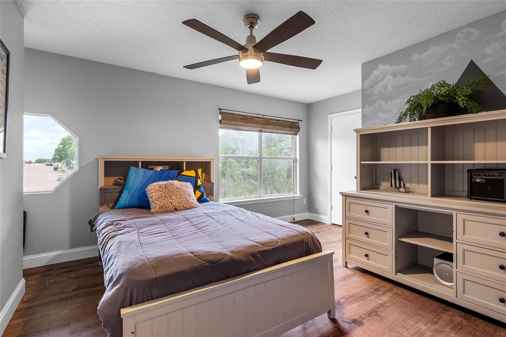1901 Yellowstone Lane Corinth, TX 76210 - Photo 14 of 32 Bedroom featuring a textured ceiling, light wood-style floors, and ceiling fan