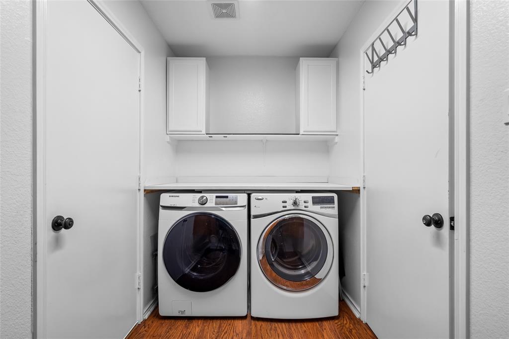 1901 Yellowstone Lane Corinth, TX 76210 - Photo 15 of 32 Washroom featuring wood finished floors, cabinet space, and washing machine and dryer