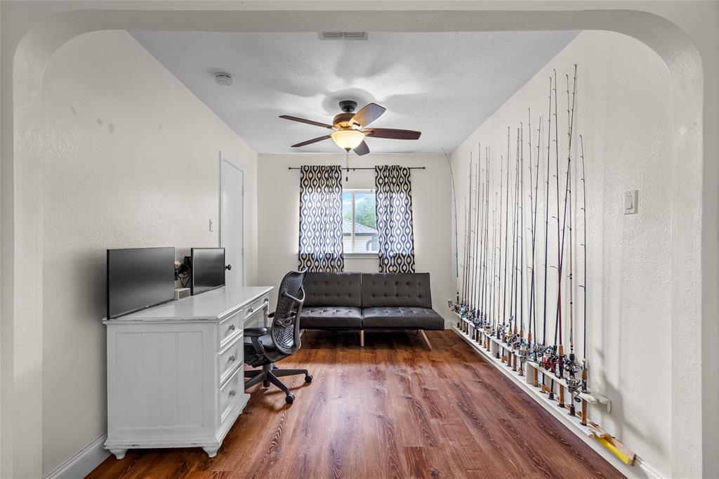 1901 Yellowstone Lane Corinth, TX 76210 - Photo 17 of 32 Office space with a textured wall, dark wood-style flooring, a ceiling fan, and arched walkways