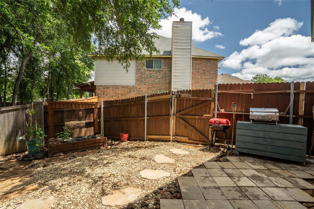 1901 Yellowstone Lane Corinth, TX 76210 - Photo 19 of 32 Fenced backyard featuring a gate and grilling area