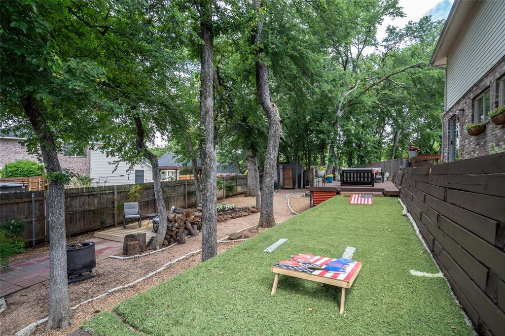 1901 Yellowstone Lane Corinth, TX 76210 - Photo 24 of 32 Fenced backyard with a deck and an outdoor fire pit