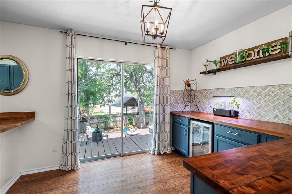 1901 Yellowstone Lane Corinth, TX 76210 - Photo 8 of 32 Kitchen featuring butcher block countertops, open shelves, blue cabinetry, dark wood-type flooring, and wine cooler
