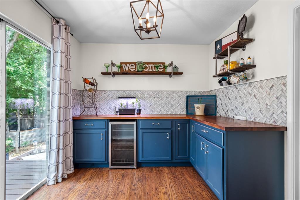 1901 Yellowstone Lane Corinth, TX 76210 - Photo 9 of 32 Indoor dry bar featuring open shelves, wooden counters, blue cabinetry, and beverage cooler