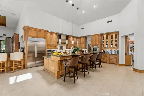 a dining room with furniture a chandelier and wooden floor